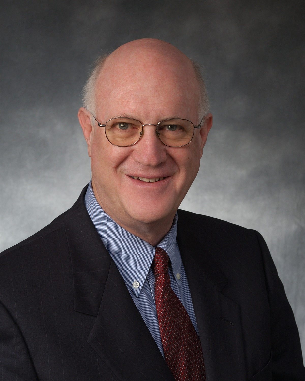 Portrait of Steve Crocker in a dark suit and red tie